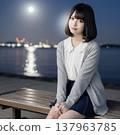 A woman sitting by the beach 137963785