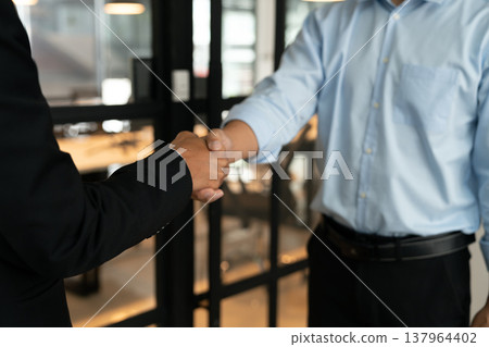 businessman stand shaking hands congratulating 137964402