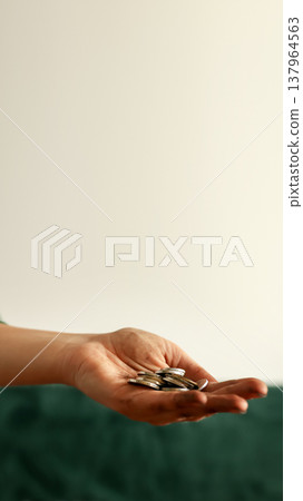 Dirty hand holding a few small coins. Poverty, financial crisis, and social inequality concept. Beggar or poor person asking for help and money with copy space Dirty hand holding a few small coins. Poverty, financial crisis, and social inequality concept. Beggar or poor person asking for help and money with copy space 137964563