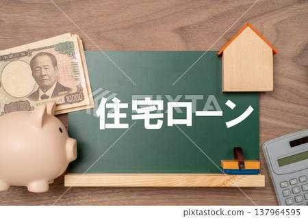 A mortgage, a piggy bank, and banknotes are written on the blackboard. 137964595
