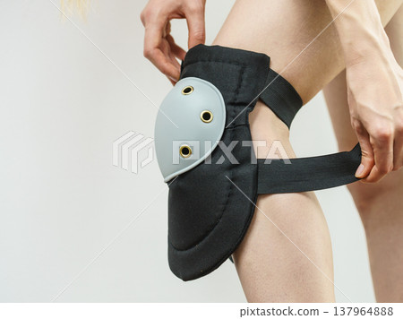 Person trying on knee pads Person trying on knee pads 137964888