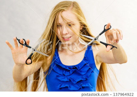 Girl with scissors for haircutting Girl with scissors for haircutting 137964922