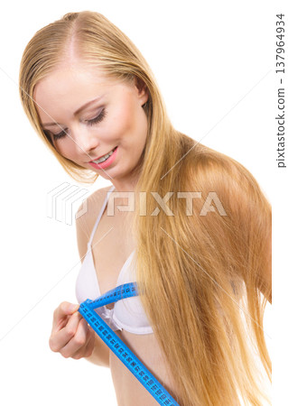 Woman measuring her chest breasts bust size Woman measuring her chest breasts bust size 137964934