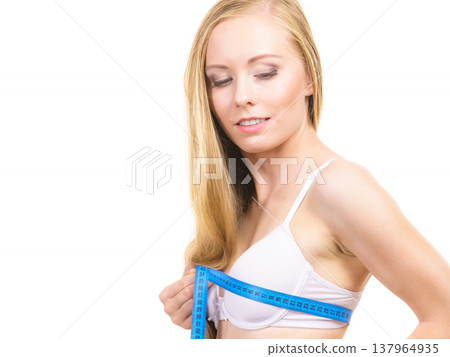 Girl measuring her chest breasts bust size Girl measuring her chest breasts bust size 137964935
