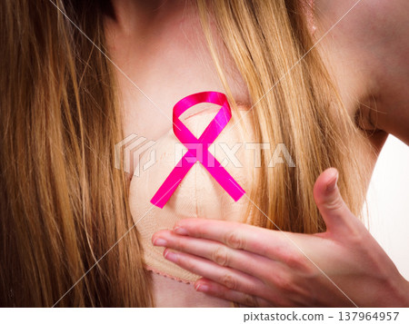 Woman chest in bra, pink cancer ribbon Woman chest in bra, pink cancer ribbon 137964957