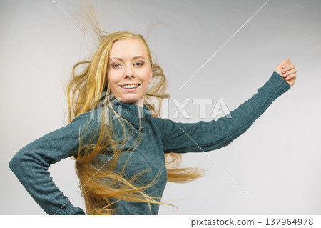 Smiling woman with blowing long hair Smiling woman with blowing long hair 137964978