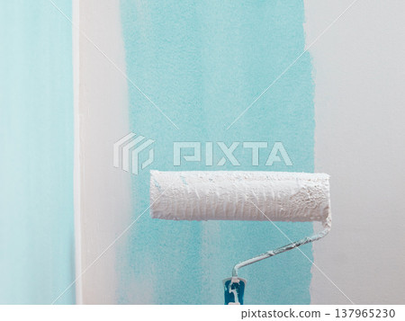 Person applying paint on wall Person applying paint on wall 137965230