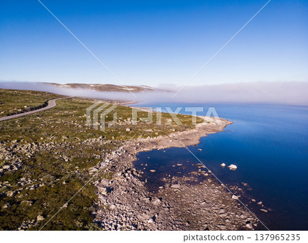 Road crossing Hardangervidda plateau, Norway. Aerial view. 137965235