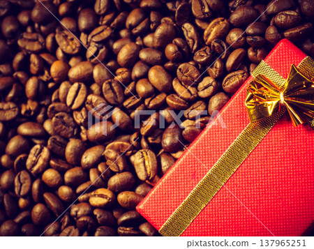 Red gift box on roasted coffee beans. 137965251