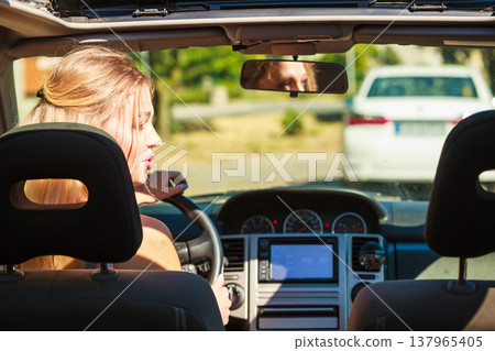 Woman driving car Woman driving car 137965405