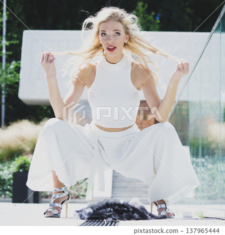 Woman wearing crop top and culottes Woman wearing crop top and culottes 137965444