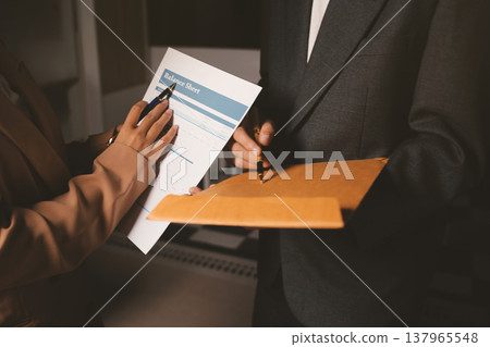 Two business people talk project strategy at office meeting room. Businessman discuss project planning with colleague at modern workplace while having conversation and advice on financial data report. Two business people talk project strategy at office meeting room. Businessman discuss project planning with colleague at modern workplace while having conversation and advice on financial data report. 137965548