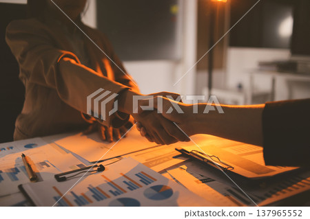 Two business people talk project strategy at office meeting room. Businessman discuss project planning with colleague at modern workplace while having conversation and advice on financial data report. Two business people talk project strategy at office meeting room. Businessman discuss project planning with colleague at modern workplace while having conversation and advice on financial data report. 137965552