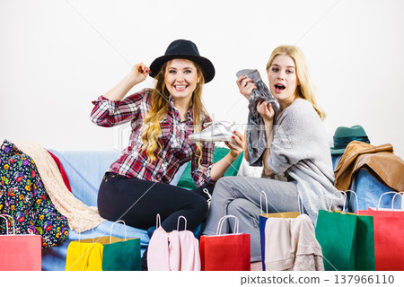 Two happy female friends after shopping 137966110