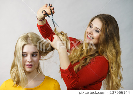 Woman with scissors ready to hair cutting 137966144