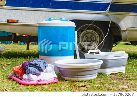 Washing laundry outdoor at caravan 137966267
