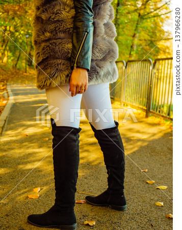 Woman wearing fur long vest during autumn Woman wearing fur long vest during autumn 137966280