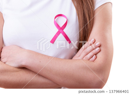 Pink ribbon on woman chest to support breast cancer cause Pink ribbon on woman chest to support breast cancer cause 137966401