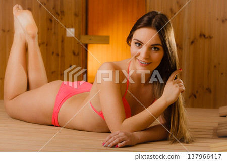 Young woman relaxing in sauna. Spa wellbeing. Young woman relaxing in sauna. Spa wellbeing. 137966417