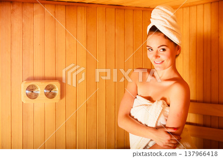 woman relaxing in wooden sauna room woman relaxing in wooden sauna room 137966418