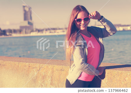 Woman resting relaxing after doing sports outdoors Woman resting relaxing after doing sports outdoors 137966462