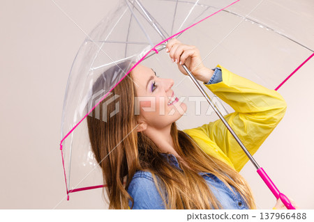 Woman wearing waterproof coat under umbrella Woman wearing waterproof coat under umbrella 137966488