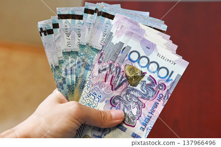 Counting banknotes on a wooden table during a financial transaction in an office setting in the afternoon Counting banknotes on a wooden table during a financial transaction in an office setting in the afternoon 137966496