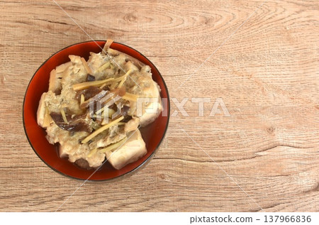 steamed white tofu stuffed mashed pork with black ear mushroom and slice ginger in soy sauce on bowl 137966836