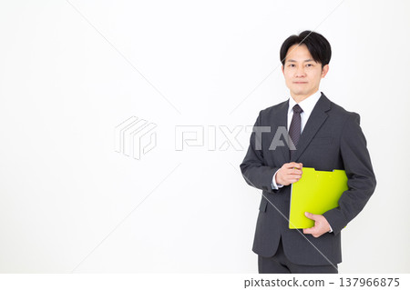 A middle-aged businessman with a binder. 137966875