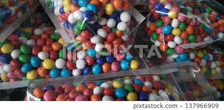 Colorful Candy-Coated Chocolates in Plastic Packaging Colorful Candy-Coated Chocolates in Plastic Packaging 137966909