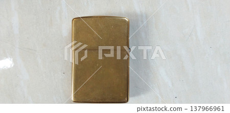 Antique Brass Lighter on Marble Surface 137966961