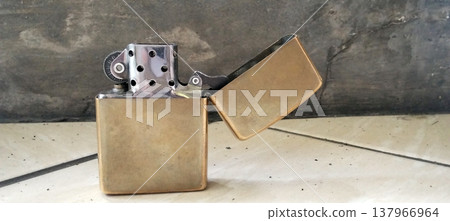 Antique Brass Lighter on Marble Surface Antique Brass Lighter on Marble Surface 137966964