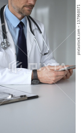 Doctor man interacting with patient during consultation, using digital tablet for modern medical healthcare technology. Medicine, healthcare and science concept Doctor man interacting with patient during consultation, using digital tablet for modern medical healthcare technology. Medicine, healthcare and science concept 137968071