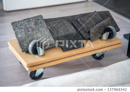 Set of tools for moving and installing window glass including wheeled dolly platform and rubber protective pads. Equipment for safe transport and handling of heavy glass panels in apartment renovation Set of tools for moving and installing window glass including wheeled dolly platform and rubber protective pads. Equipment for safe transport and handling of heavy glass panels in apartment renovation 137968342
