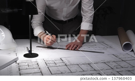 Architect hands drawing blueprint for new building design, working on infrastructure project plans at night. Business and architect people concept Architect hands drawing blueprint for new building design, working on infrastructure project plans at night. Business and architect people concept 137968403