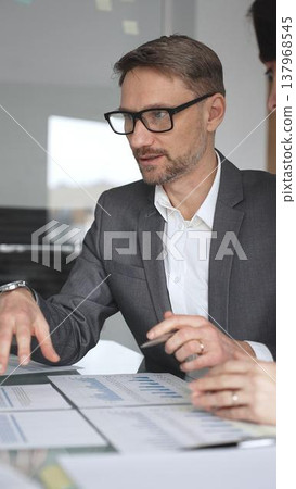 Business people hands clapping during a corporate meeting, showing appreciation for a successful presentation, celebrating achievement and expressing support in the office environment, vertical view 137968545
