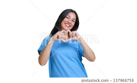 Woman forming heart gesture with fingers smiling expressing love Woman forming heart gesture with fingers smiling expressing love 137968758