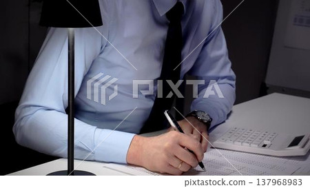 Professional businessman analyzing financial data and statistics, calculating costs, making important budget reports at office desk. Audit and taxes theme in business Professional businessman analyzing financial data and statistics, calculating costs, making important budget reports at office desk. Audit and taxes theme in business 137968983