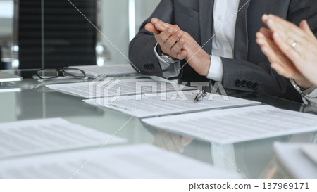 Business people applauding during a meeting, celebrating a successful deal, contract signing, or new partnership agreement. Businesspeople concept Business people applauding during a meeting, celebrating a successful deal, contract signing, or new partnership agreement. Businesspeople concept 137969171