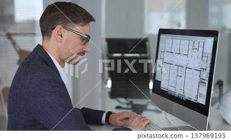 Architect developing building blueprint on computer, engineering and urban planning a new construction project. Business and architecture concept Architect developing building blueprint on computer, engineering and urban planning a new construction project. Business and architecture concept 137969193