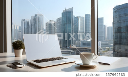 Modern office workspace with laptop coffee and city skyline visible through window 137969583