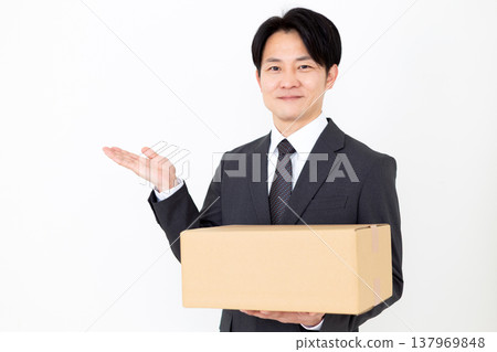 一位中年商人扛著紙箱。 137969848