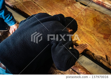 Christian pilgrims on the Stone of Anointing, Holy Sepulchre in Jerusalem. 137970016
