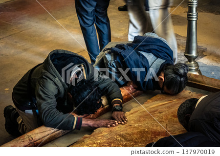 Christian pilgrims on the Stone of Anointing, Holy Sepulchre in Jerusalem. Christian pilgrims on the Stone of Anointing, Holy Sepulchre in Jerusalem. 137970019