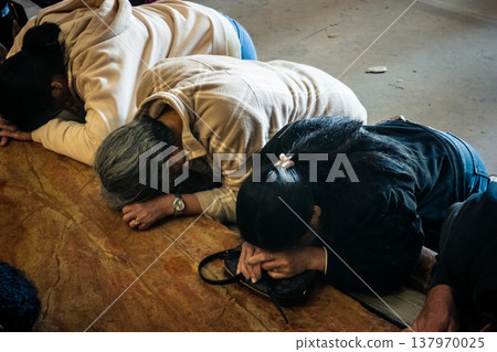 Christian pilgrims on the Stone of Anointing, Holy Sepulchre in Jerusalem. Christian pilgrims on the Stone of Anointing, Holy Sepulchre in Jerusalem. 137970025