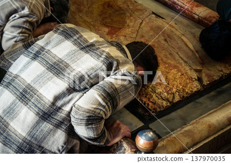 Christian pilgrims on the Stone of Anointing, Holy Sepulchre in Jerusalem. 137970035