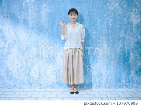 A woman in her 60s smiling and looking at the camera. A woman in her 60s smiling and looking at the camera. 137970999