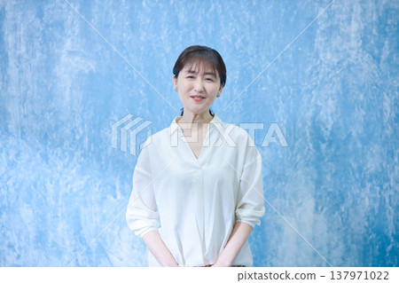A woman in her 60s smiling and looking at the camera. A woman in her 60s smiling and looking at the camera. 137971022