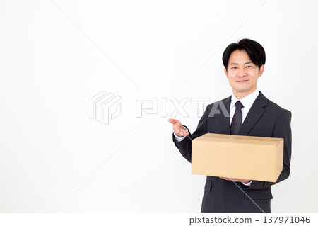 A middle-aged businessman carrying cardboard boxes. A middle-aged businessman carrying cardboard boxes. 137971046