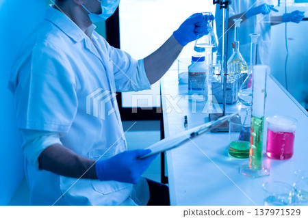 Chemical scientist are experimenting with various chemicals Chemical scientist are experimenting with various chemicals 137971529